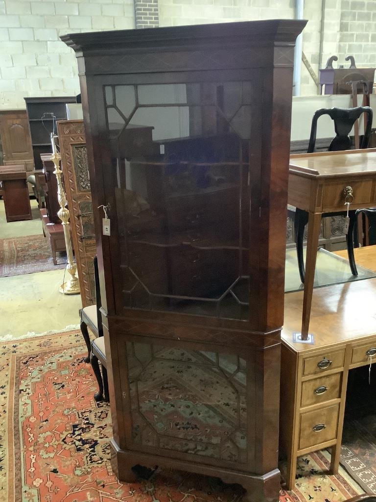 A reproduction mahogany standing corner cabinet, width 86cm depth 56cm height 205cm